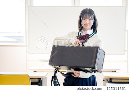 一名帶著樂器盒的學生 一名帶著樂器盒的學生 125311861