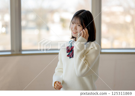 Smiling student talking on the phone 125311869
