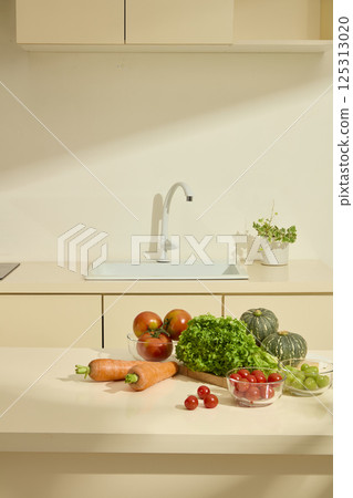 Organic vegetables placed on wooden cutting boards neatly placed on a marble table. Green pots placed next to the clean sink with white faucet. Daylight shine in the kitchen with modern appliances. 125313020
