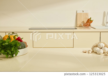 Empty marble kitchen counters used to place products. Fresh vegetables are placed on white round plates and some garlic bulbs are randomly placed on the table. Kitchen Interior Background. Empty marble kitchen counters used to place products. Fresh vegetables are placed on white round plates and some garlic bulbs are randomly placed on the table. Kitchen Interior Background. 125313025