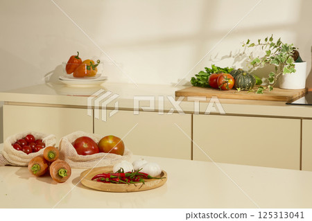 Composition of different vegetables placed in the corners of the kitchen. Light shines in and makes the kitchen more warm and clear. Vegetables are cooking ingredients with many health benefits. Composition of different vegetables placed in the corners of the kitchen. Light shines in and makes the kitchen more warm and clear. Vegetables are cooking ingredients with many health benefits. 125313041