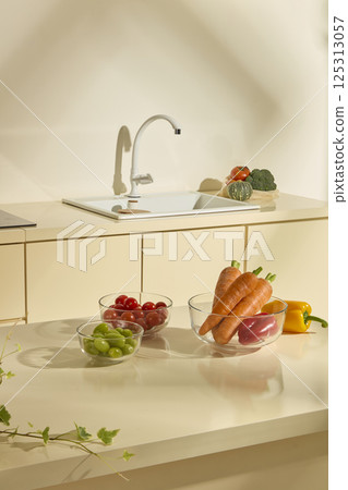 Fresh vegetables and colorful fruits with many vitamins good for health, are organic ingredients to prepare many delicious dishes. The kitchen scene behind with the sink and electric stove. Fresh vegetables and colorful fruits with many vitamins good for health, are organic ingredients to prepare many delicious dishes. The kitchen scene behind with the sink and electric stove. 125313057