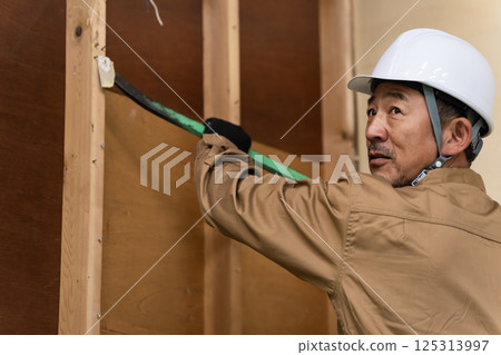 Middle-aged man working at a construction site Middle-aged man working at a construction site 125313997