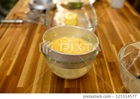 Close up of butter and buttermilk separation on wooden countertop 125314577