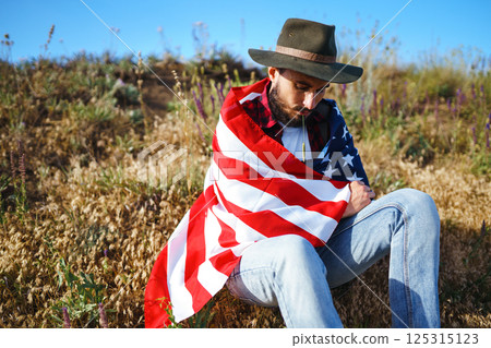4th of July. American Flag.Patriotic holiday. Traveler with the flag of America. Beautiful sunset light. American style. 4th of July. American Flag.Patriotic holiday. Traveler with the flag of America. Beautiful sunset light. American style. 125315123