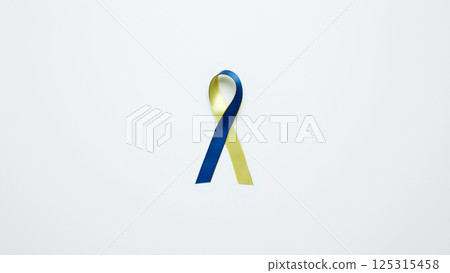 Symbolizing World Down Syndrome Day. A yellow and blue awareness ribbon 125315458