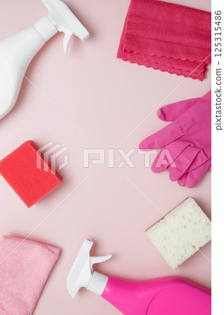 Household cleaning and hygiene concept. Pink cleaning supplies including rubber gloves, spray bottle, sponge, and microfiber cloths Household cleaning and hygiene concept. Pink cleaning supplies including rubber gloves, spray bottle, sponge, and microfiber cloths 125315486