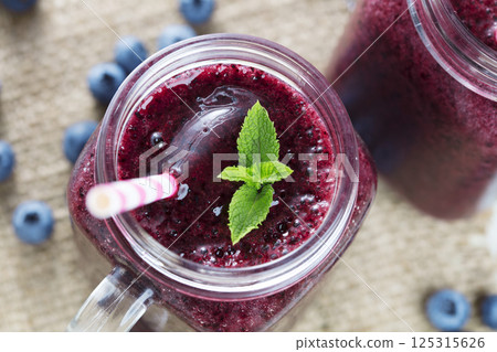 Berry smoothie on wooden table 125315626