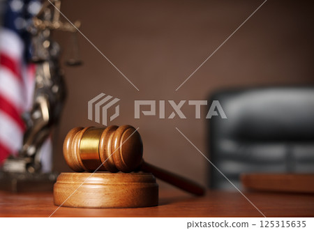 Wooden gavel on judge's table 125315635