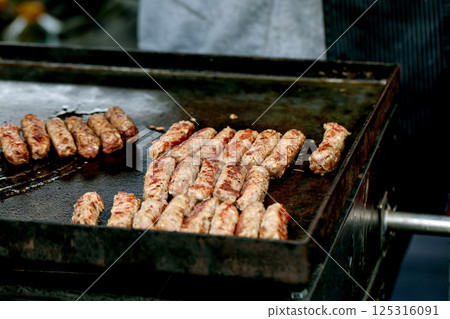 Grilled Meat Kebabs On Cooking Griddle 125316091