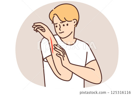 Man examines hand with deep cut or wound received after accident at work 125316116