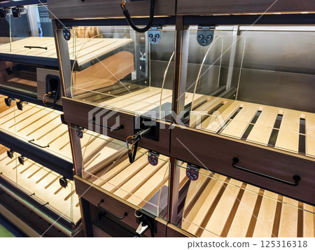 Wooden display boxes arranged for showcasing products in a retail environment 125316318