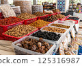Display case with colorful nuts and dried fruits at a traditional oriental bazaar in Samarkand 125316987