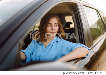 Two young women on car trip having fun. Lifestyle, travel, tourism, nature, active life. 125317153
