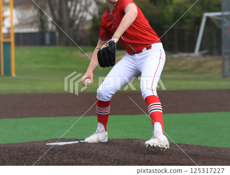 A Baseball Pitcher starts to make his throw to the plate A Baseball Pitcher starts to make his throw to the plate 125317227
