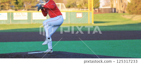 High School Baseball Pitcher Pitching the Ball During a Game High School Baseball Pitcher Pitching the Ball During a Game 125317233