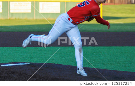 High School Baseball Pitcher Throws a Fastball on the Field High School Baseball Pitcher Throws a Fastball on the Field 125317234