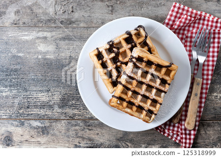 Belgian Waffles with chocolate on on wooden table 125318999