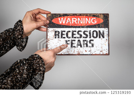 Recession Fears. Warning sign with text in the hands of a woman 125319193