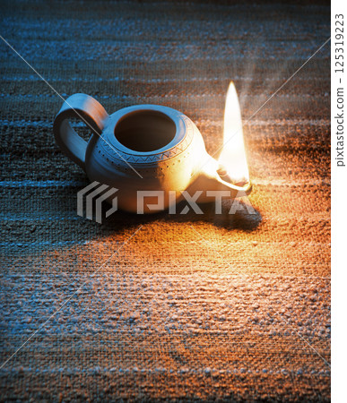 Ancient lamp shines in the dark Ancient lamp shines in the dark 125319223