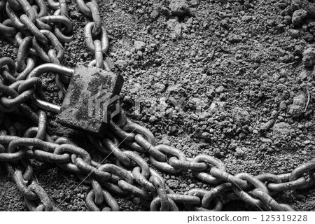 An old metal chain lies on the ground An old metal chain lies on the ground 125319228