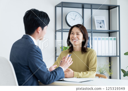 Middle-aged woman consulting a planner 125319349