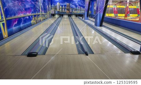 Sports hall for bowling. Pin lanes and colorful balls. Family recreation. Sports hall for bowling. Pin lanes and colorful balls. Family recreation. 125319595