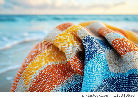 Beach towel with bold geometric patterns in summer beach. Retro style. Close-up. 125319656