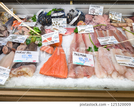Fresh fish on ice at the Holesovice market displaying salmon, cod, octopus, and mussels in Prague, Czech republic 125320009