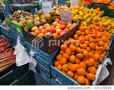 Fresh produce displayed at a vibrant farmers Holesovice market, offering apples, tangerines, lemons, pears, ginger and rhubarb in Prague, Czech republic 125320026