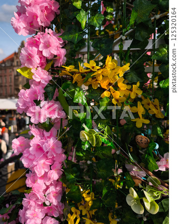 Pink and yellow artificial flowers decorating easter market in prague old town square Pink and yellow artificial flowers decorating easter market in prague old town square 125320164