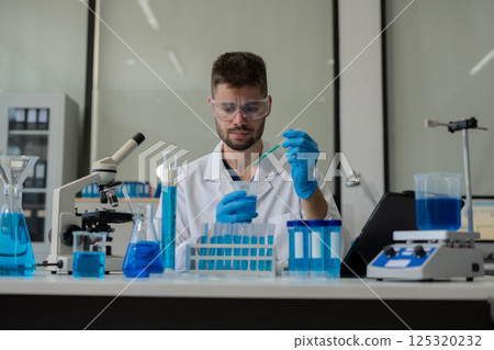 Chemist scientist holding test tube conducting experiment in laboratory with equipment. Chemist scientist holding test tube conducting experiment in laboratory with equipment. 125320232