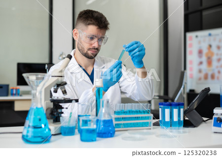 Chemist scientist holding test tube conducting experiment in laboratory with equipment. Chemist scientist holding test tube conducting experiment in laboratory with equipment. 125320238