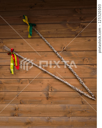 Two braided whips hanging on wooden wall with colorful ribbons copy space easter in Prague Two braided whips hanging on wooden wall with colorful ribbons copy space easter in Prague 125320303