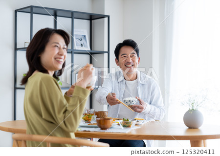 Middle-aged couple eating breakfast 125320411