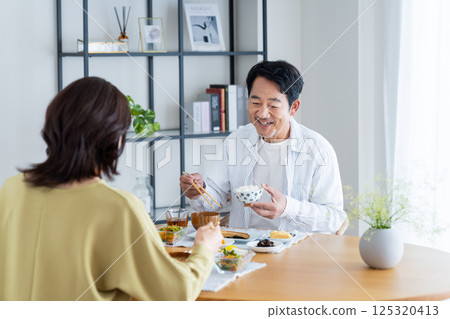 Middle-aged couple eating breakfast 125320413