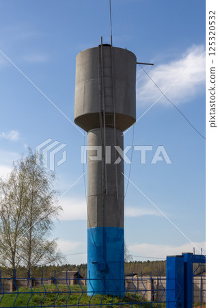 water tower in the village, central water supply in private area 125320532