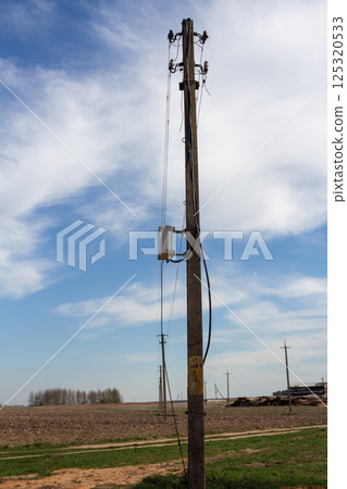Electric poles with power lines at sunset. Electricity transmission. Electric poles with power lines at sunset. Electricity transmission. 125320533