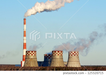 Power plant releases steam into the atmosphere on a clear sunny day near the industrial area Power plant releases steam into the atmosphere on a clear sunny day near the industrial area 125320715