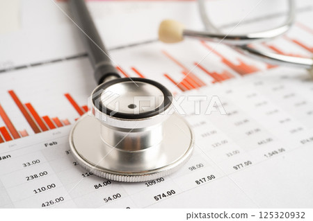 Stethoscope on chart paper, Financial, account, statistics and business data medical health. Stethoscope on chart paper, Financial, account, statistics and business data medical health. 125320932