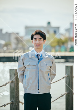 A young man in his 20s wearing work clothes 125322071