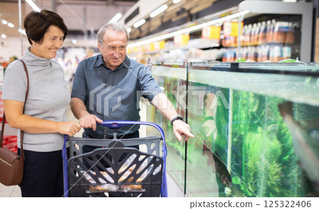Couple choose fish for festive dinner 125322406