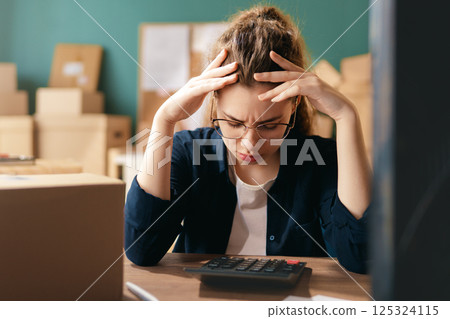 Woman working in a warehouse. Woman working in a warehouse. 125324115