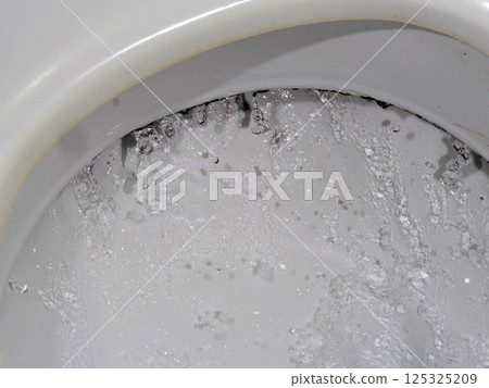 old toilet flushing detail of water running 125325209
