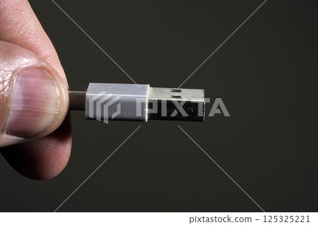 hand holding usb plug close up 125325221