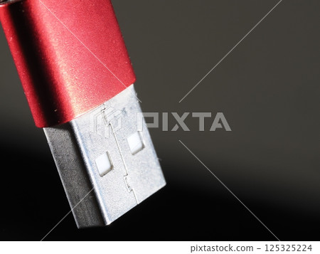 Red holding usb plug close up 125325224