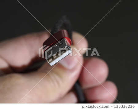 hand holding a red usb plug close up 125325226