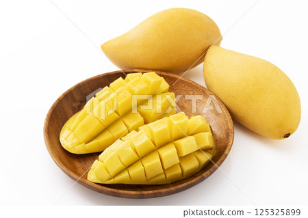 Thai mango on a wooden plate Thai mango on a wooden plate 125325899