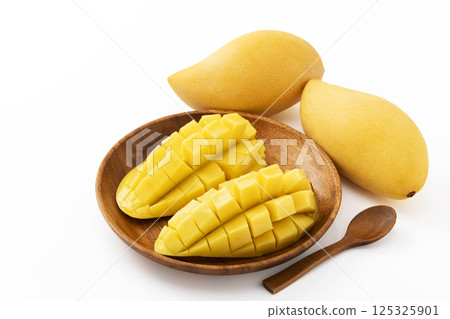 Thai mango on a wooden plate Thai mango on a wooden plate 125325901