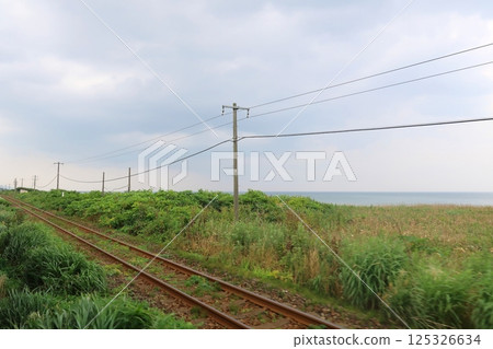 JR Hokkaido, Hakodate Main Line, local train window view from Yakumo Station to Oshamanbe Station (cloudy sky in summer 2023) 125326634